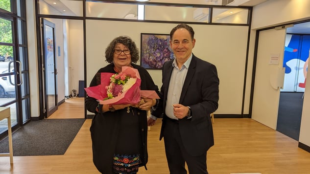 Our CEO, Peter, pictured with Kathleen holding flowers